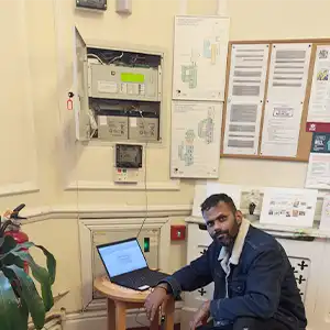 Engineer carrying out electrical and fire alarm inspection work