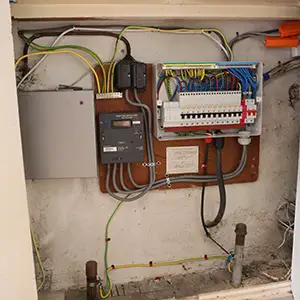 TT earthing system board change in DA8 showing upgraded distribution board, new wiring, and improved safety arrangement.