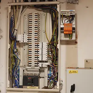 Commercial distribution board with three SWA cables terminated and surge protection device installed.
