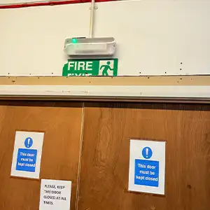 Fire Exit & Fire Door Compliance — Checking signage, door condition, and emergency lighting