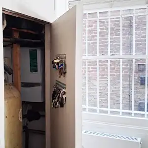 Non–Fire‑Rated Boiler Cupboard — Identifying inadequate compartmentation around hot water systems and potential fire spread risks
