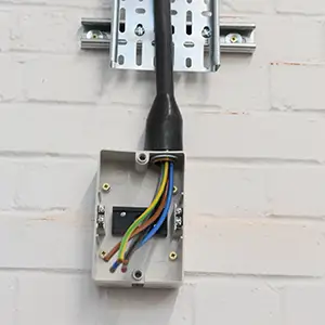 Terminating cables into a commercial three‑phase isolator.