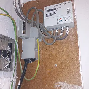 Main electrical service head showing earthing arrangement, main earthing terminal, bonding, and DNO fuse inspected during an EICR.