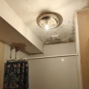 IP45 bathroom ceiling light inspected during an EICR to ensure suitability for shower zone moisture protection.