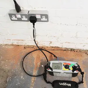 Megger tester showing Zs reading during commercial installation testing.